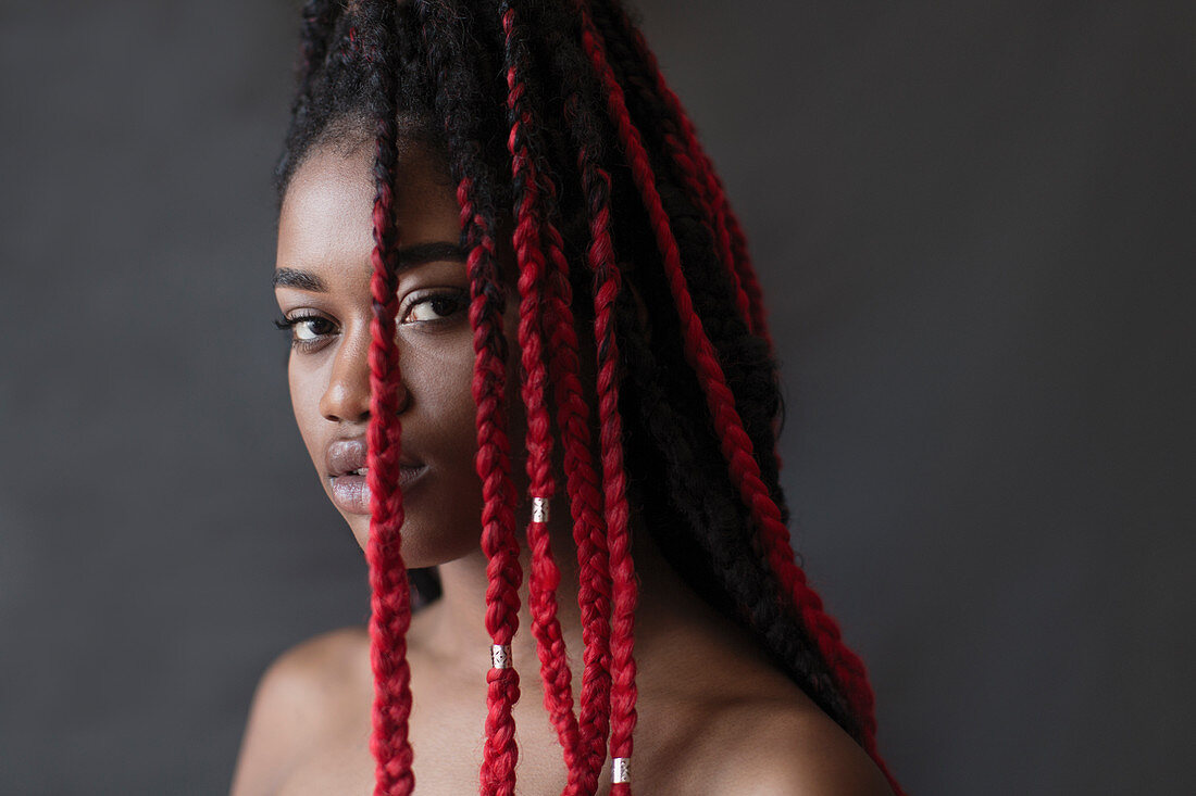 Portrait serious young woman with red braids