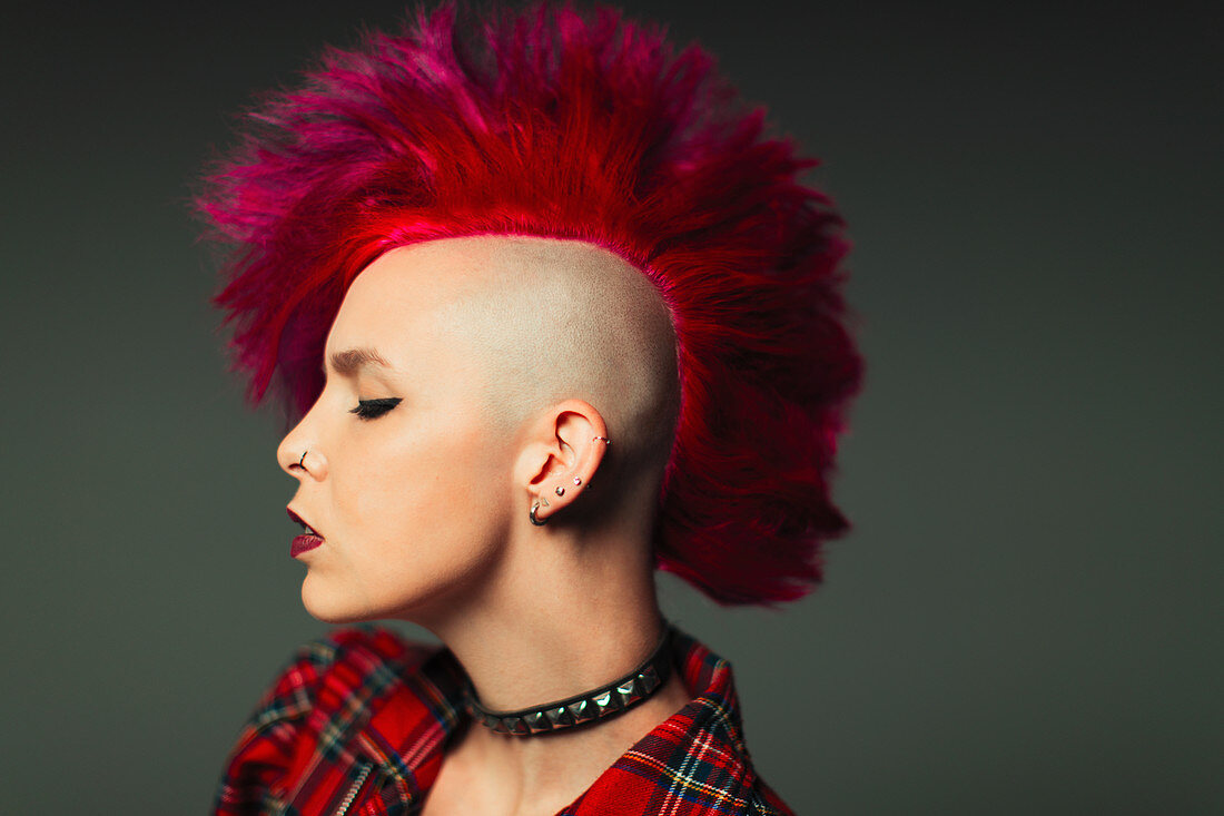 Profile of young woman with pink mohawk