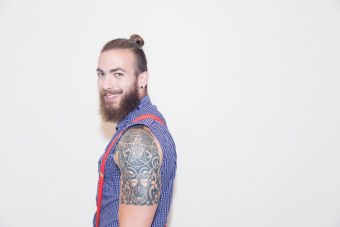 Portrait male hipster with shoulder tattoo