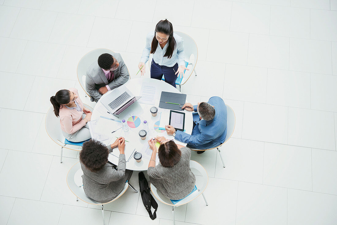 Businesswoman leading meeting at round table