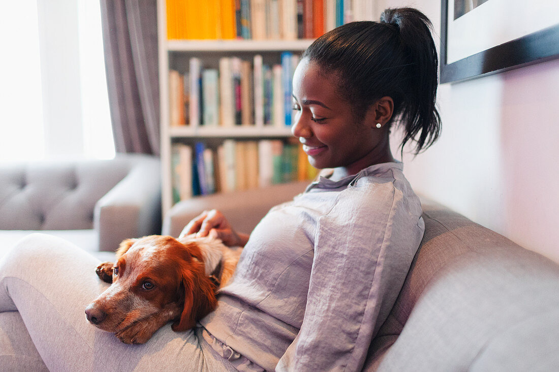 Young woman cuddling with dog