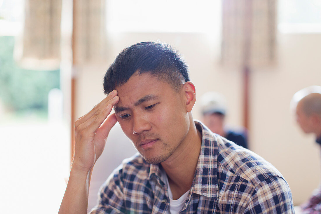 Frustrated man with head in hands