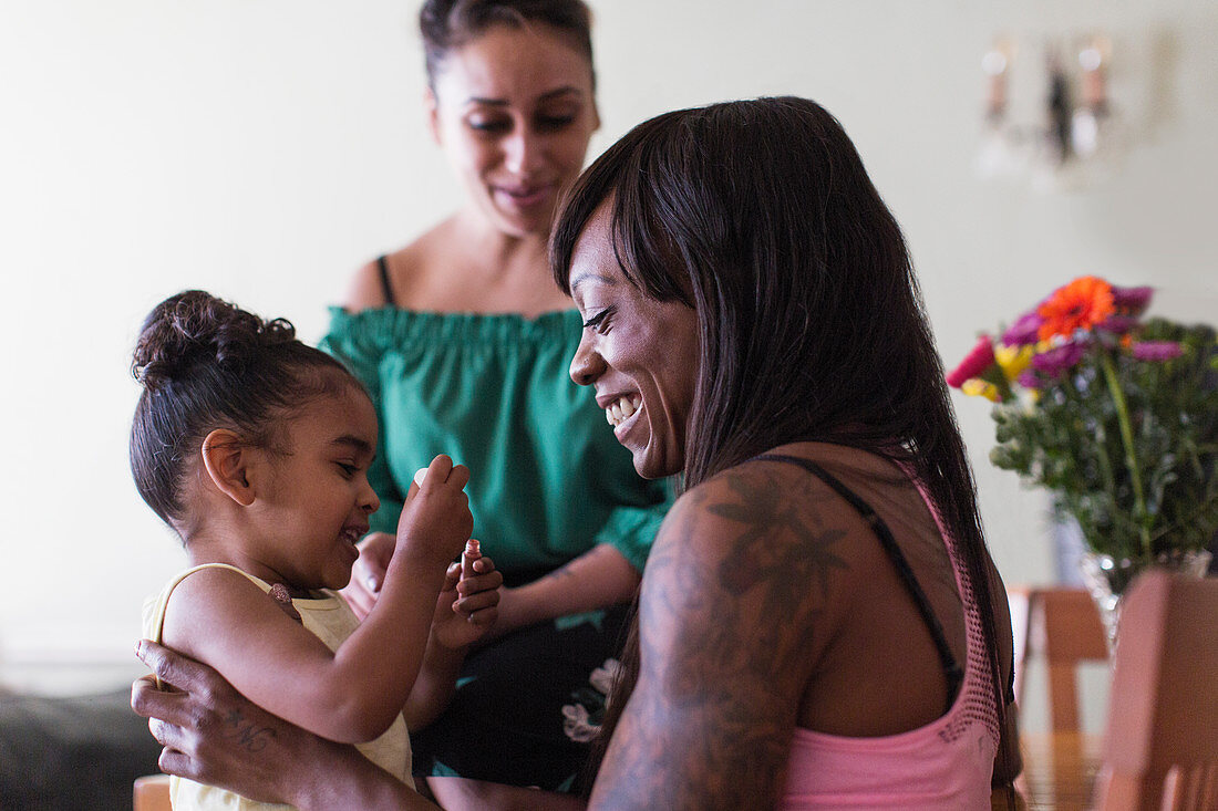 Lesbian couple playing with daughter