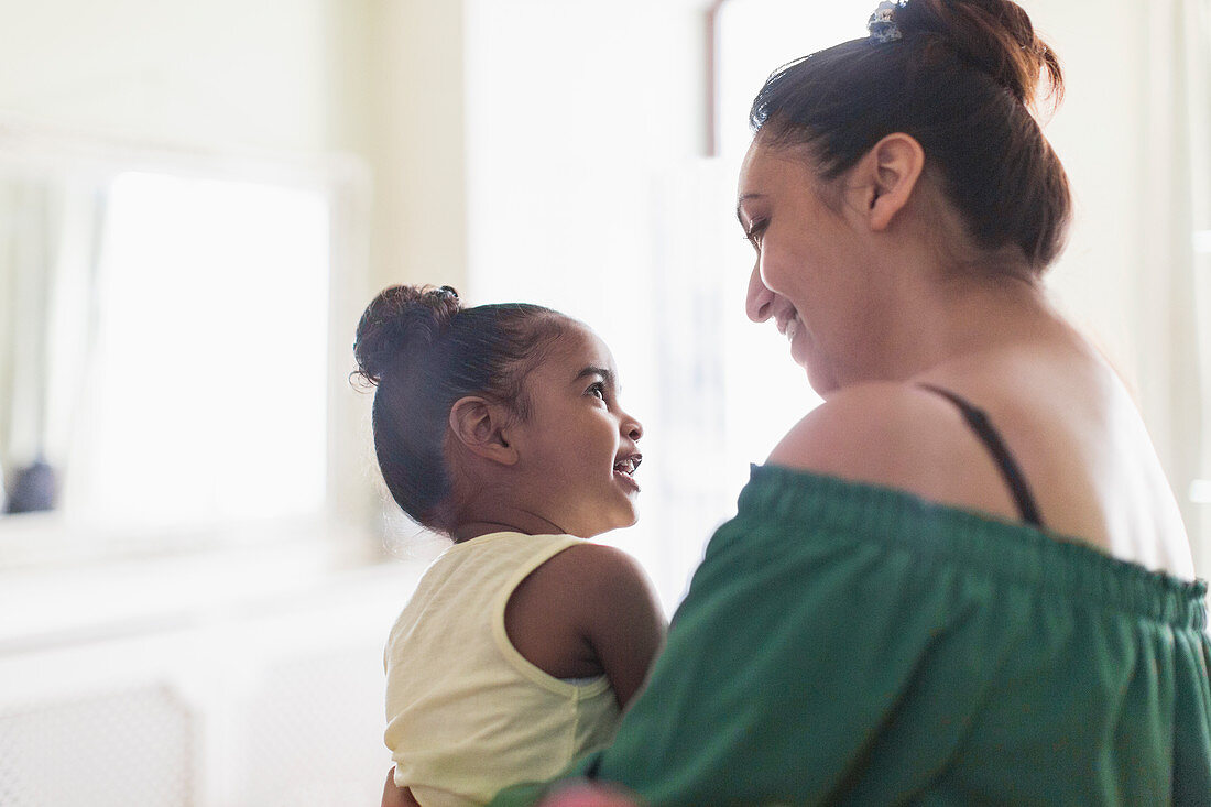 Mother and toddler daughter talking