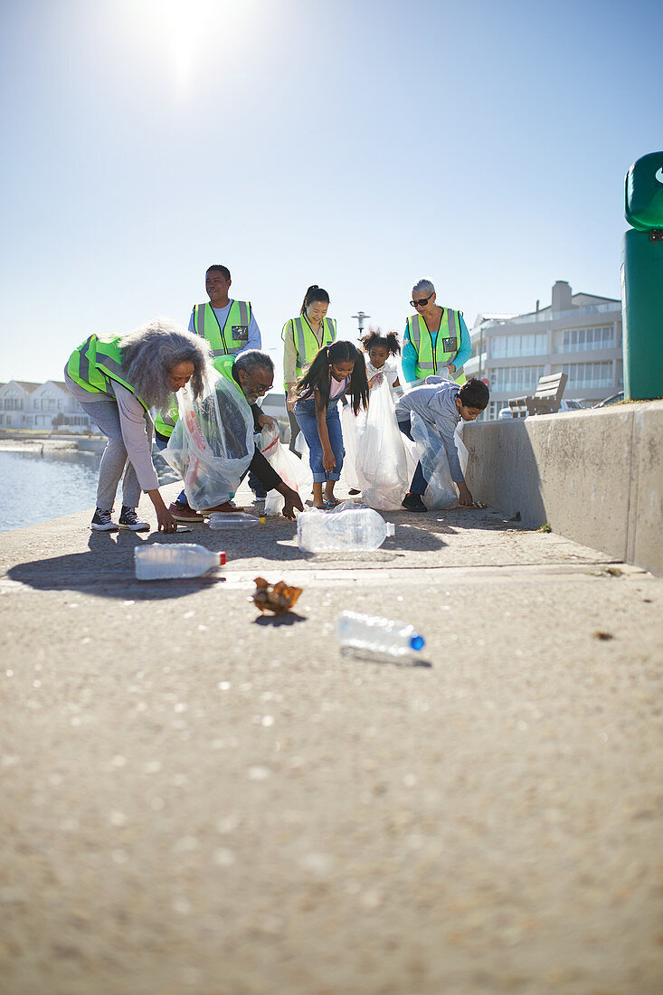 Volunteers picking up plastic litter on boardwalk