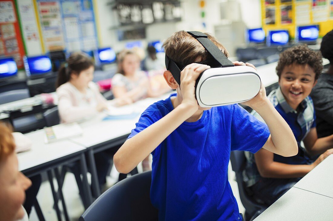 school boy student using virtual reality simulator glasses