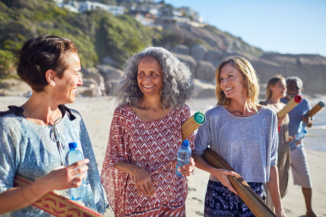 friends with yoga mats talking