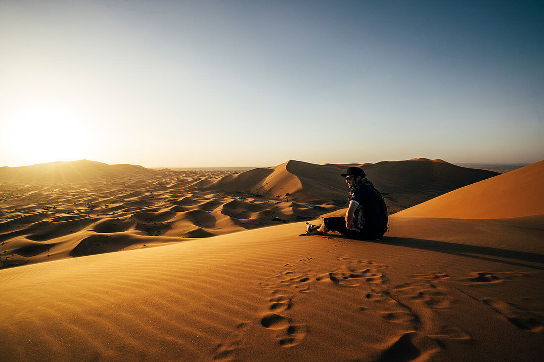 Male traveller enjoying desert view, Sahara, Morocco