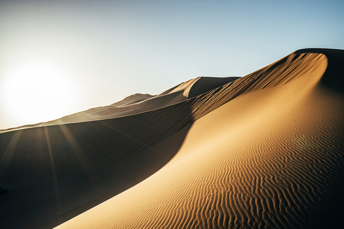 Sun shining over desert, Sahara, Morocco