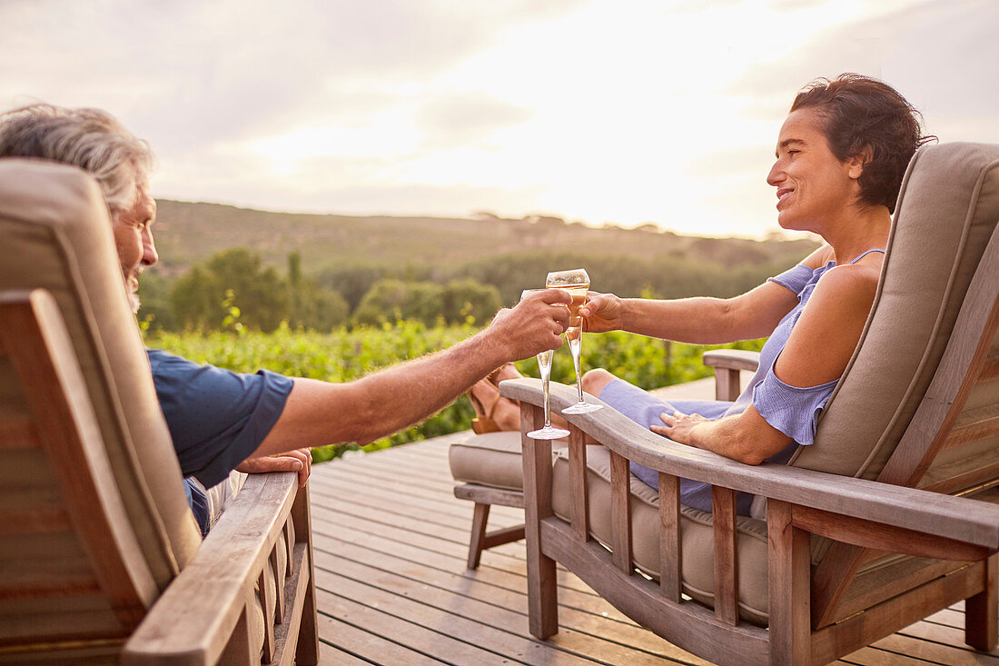 Couple relaxing with champagne on resort patio