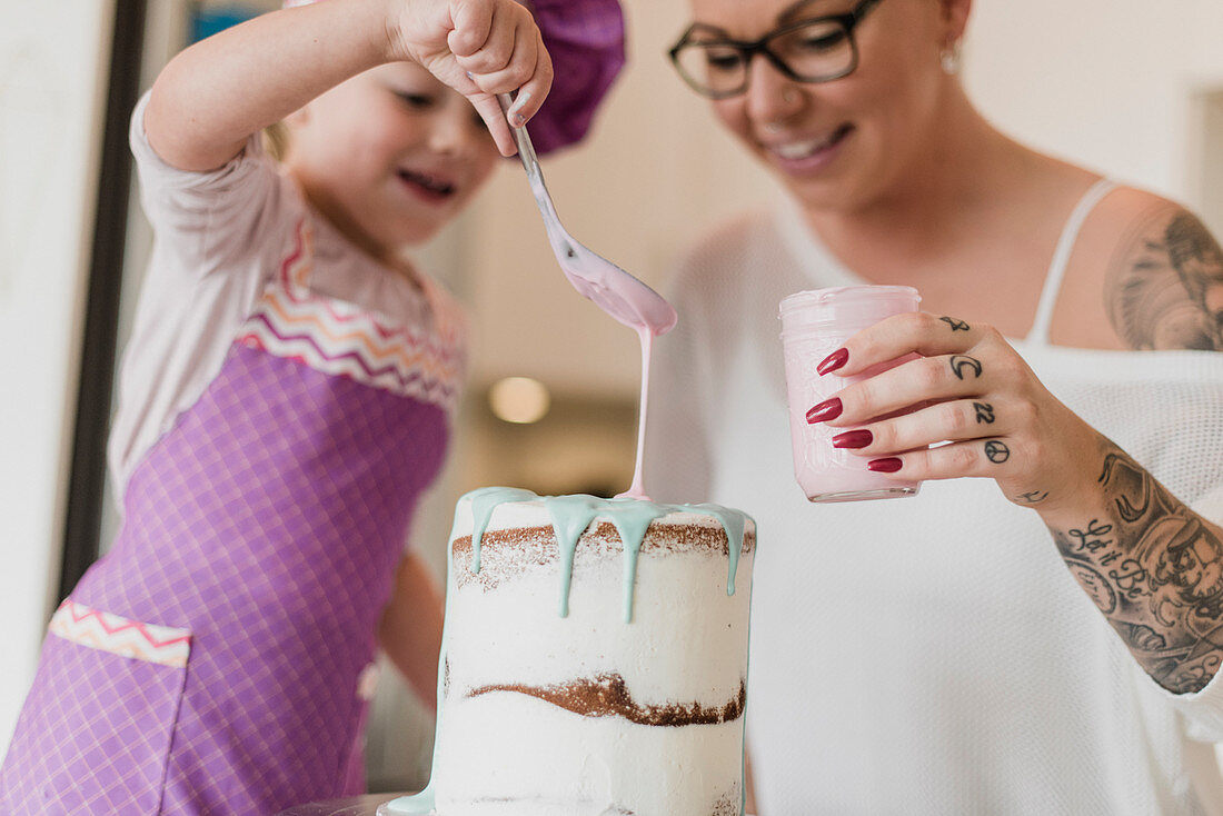 Mother and daughter decorating cake