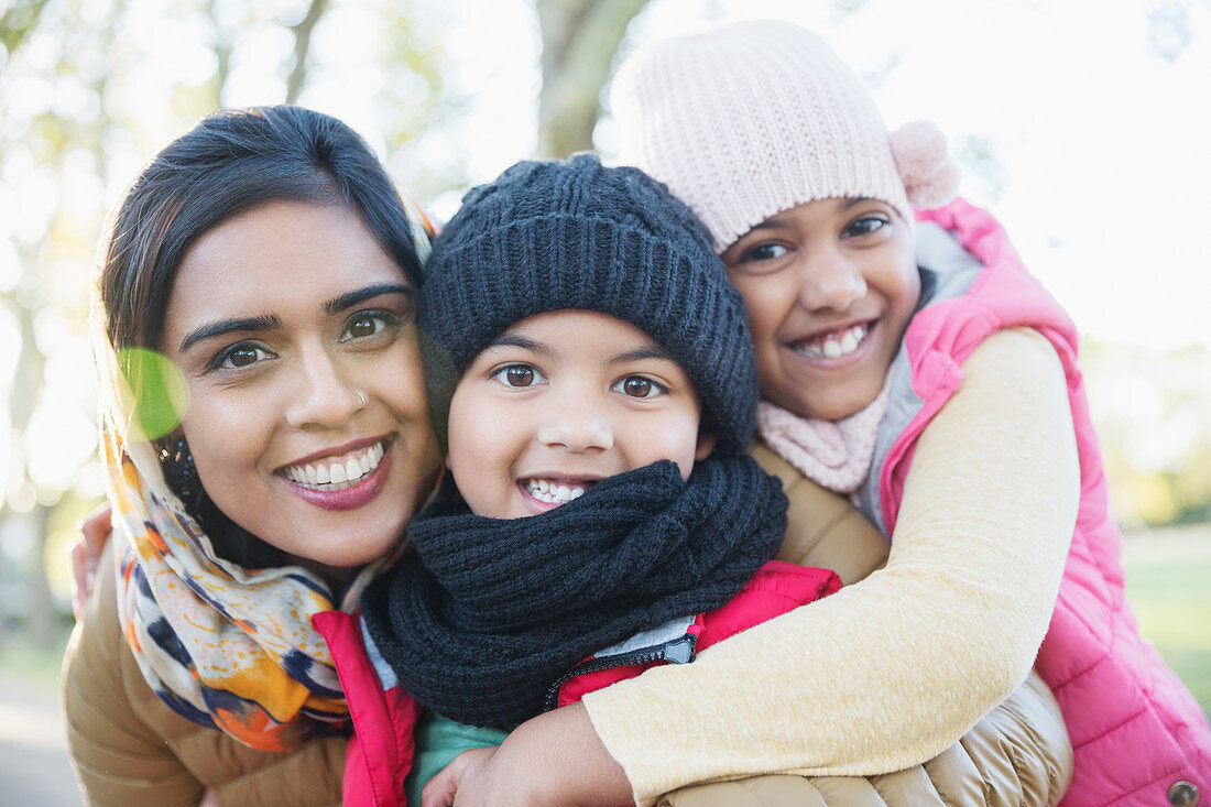 Portrait happy mother and children hugging