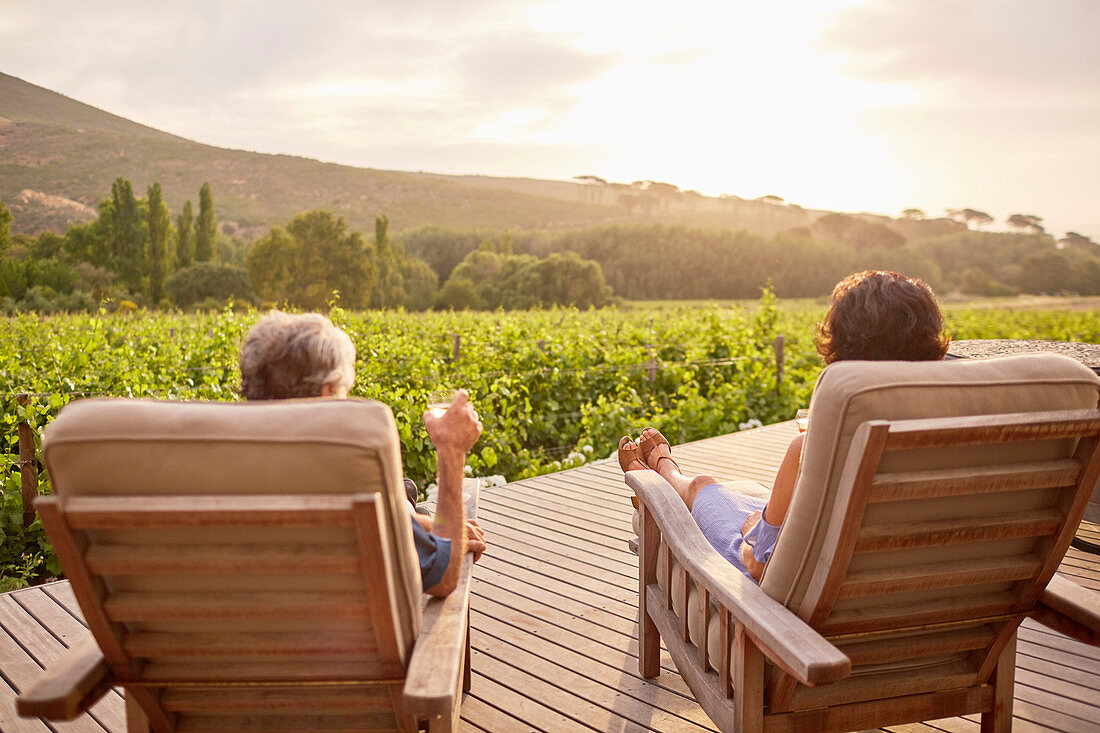 Couple relaxing, drinking wine on resort patio