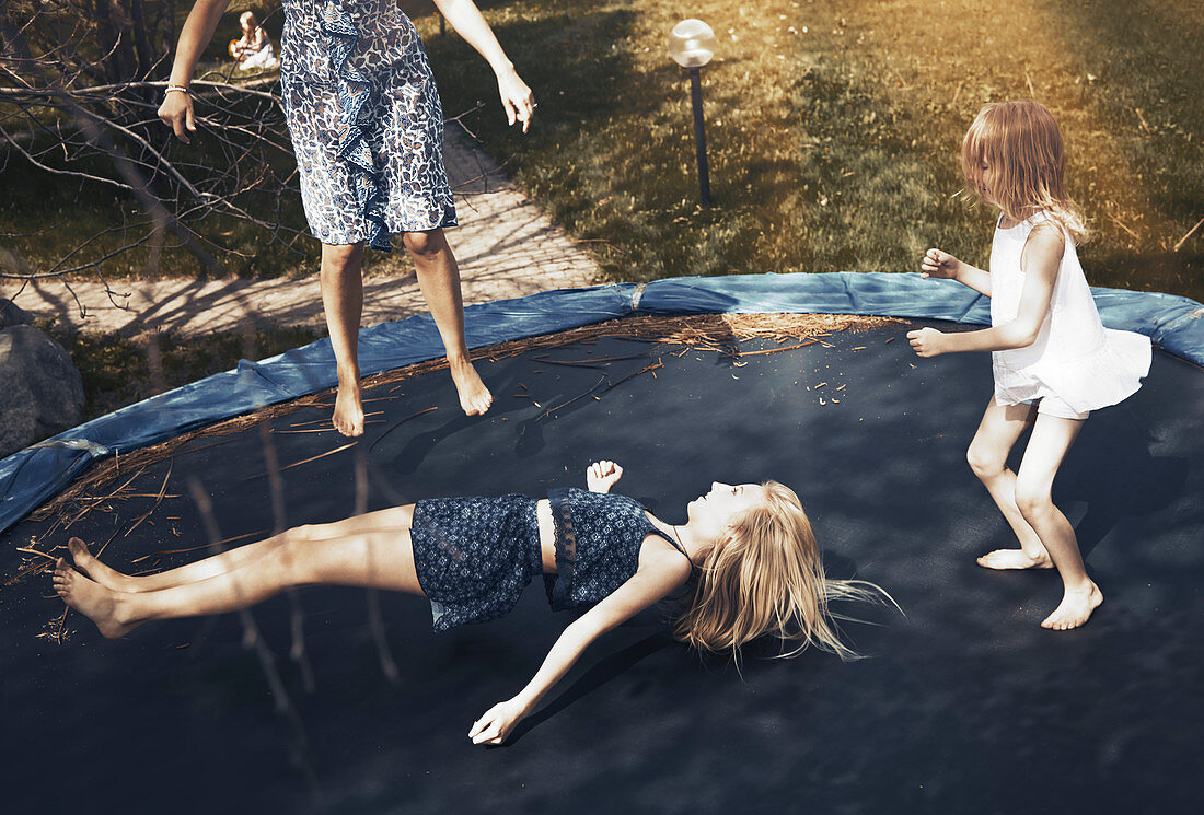 Happy family jumping on trampoline