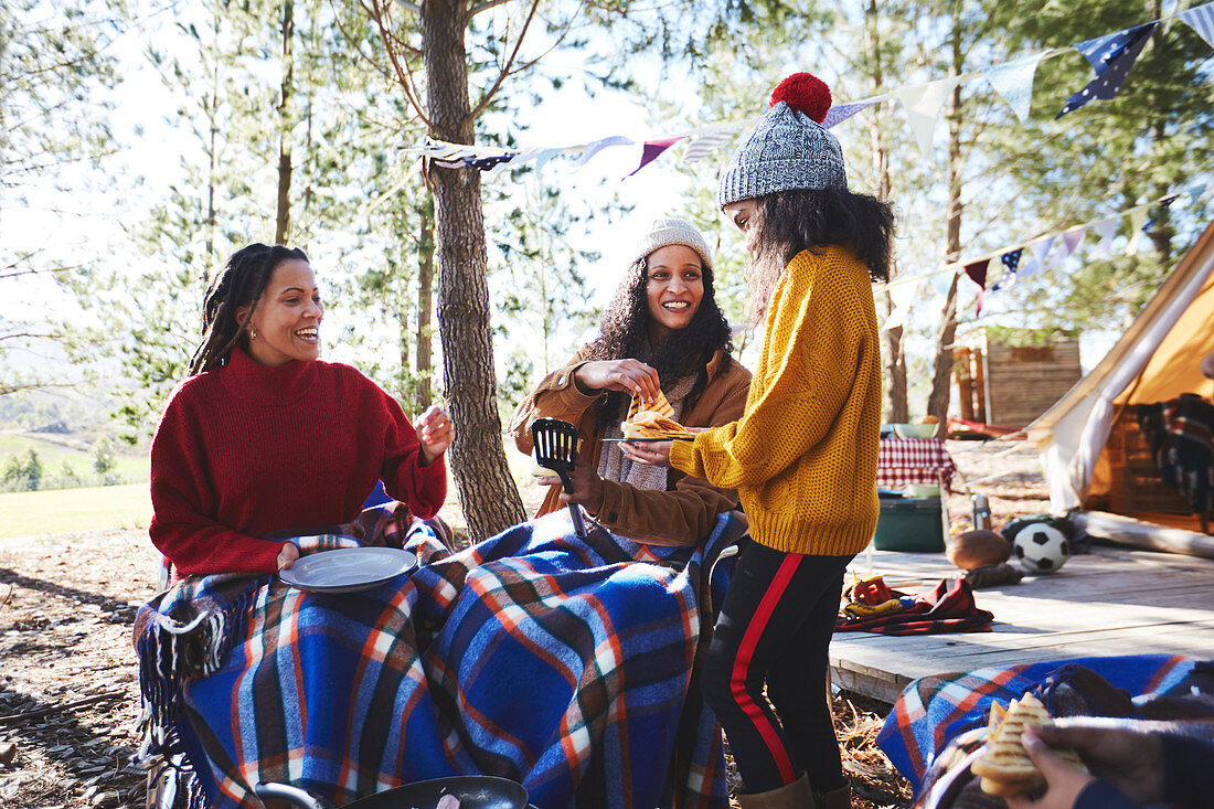 Happy lesbian couple and daughter enjoying breakfast