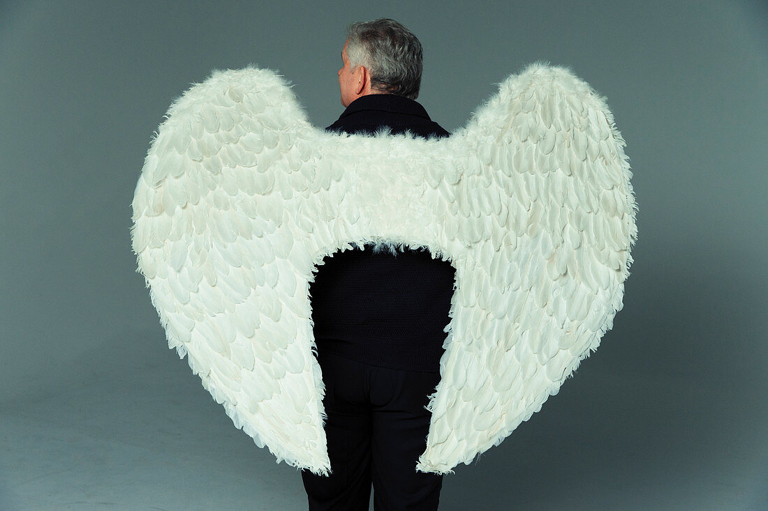 Serene man wearing angel wings