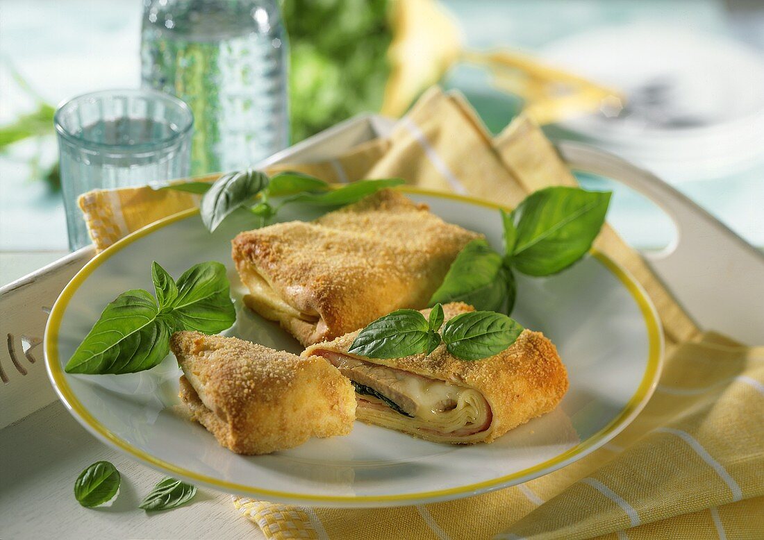 Oven-baked crepes with pork fillet, ham & cheese filling