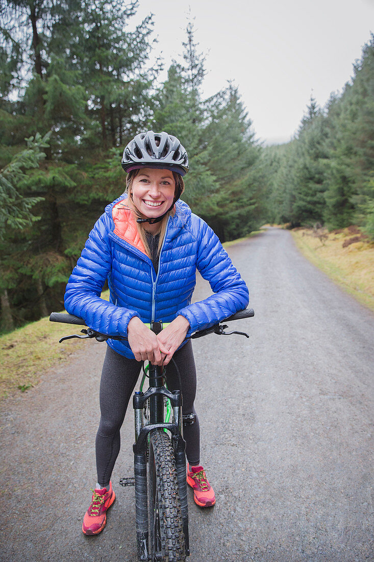 Smiling woman mountain biking