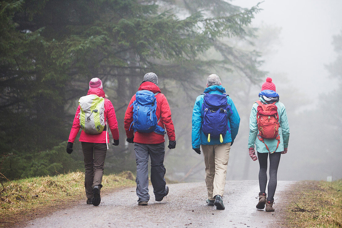 Family hiking in rain