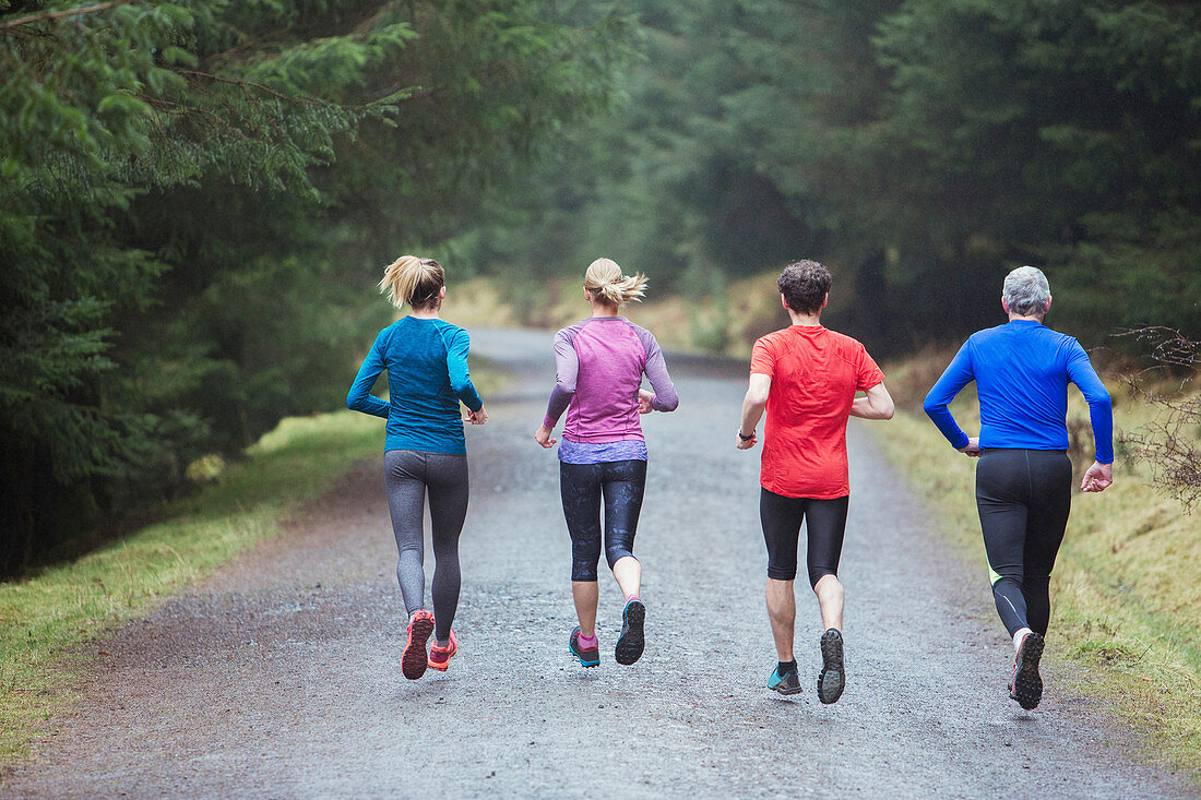 Family jogging in woods