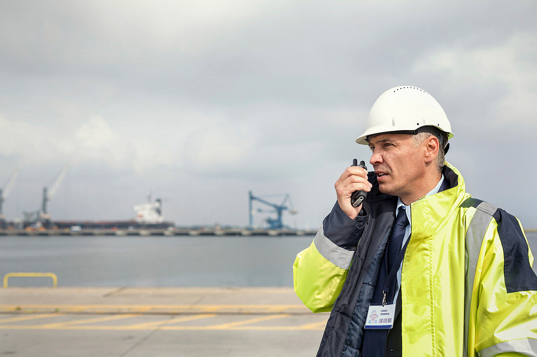 Dock manager with walkie-talkie at shipyard