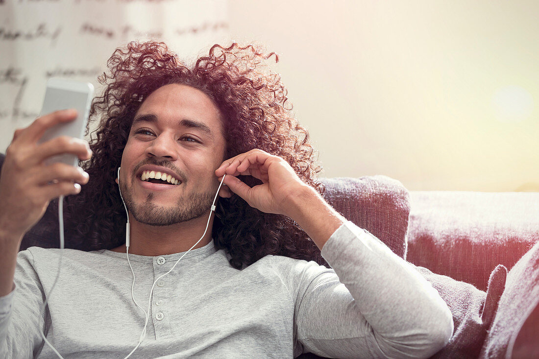 Smiling man listening to music with headphones