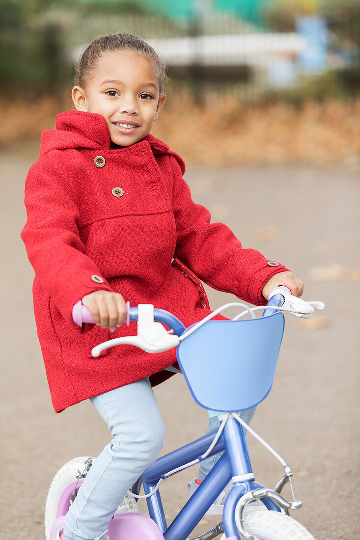 Portrait girl riding bicycle