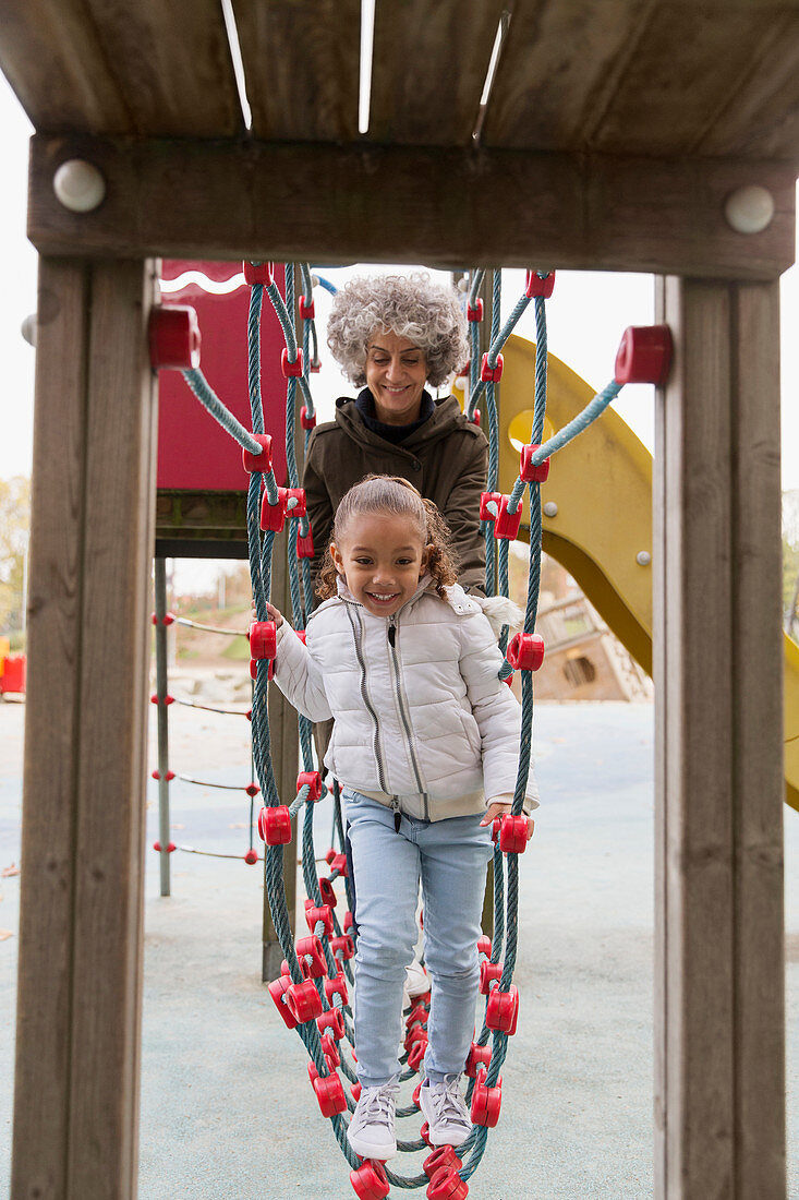 Grandmother and granddaughter playing on playground