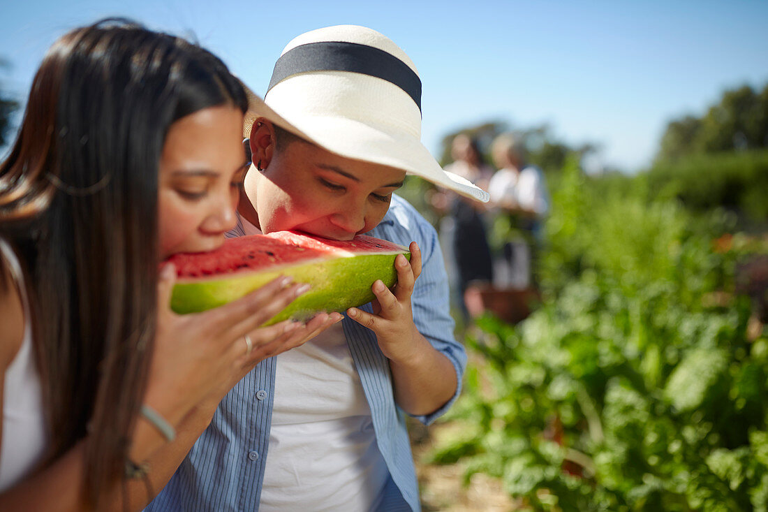 Young women eating farm fresh watermelon