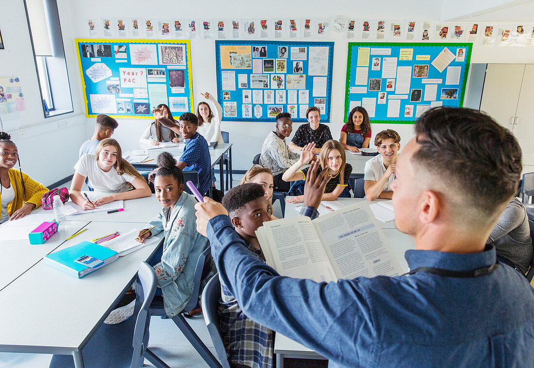 Teacher calling on students during lesson in classroom