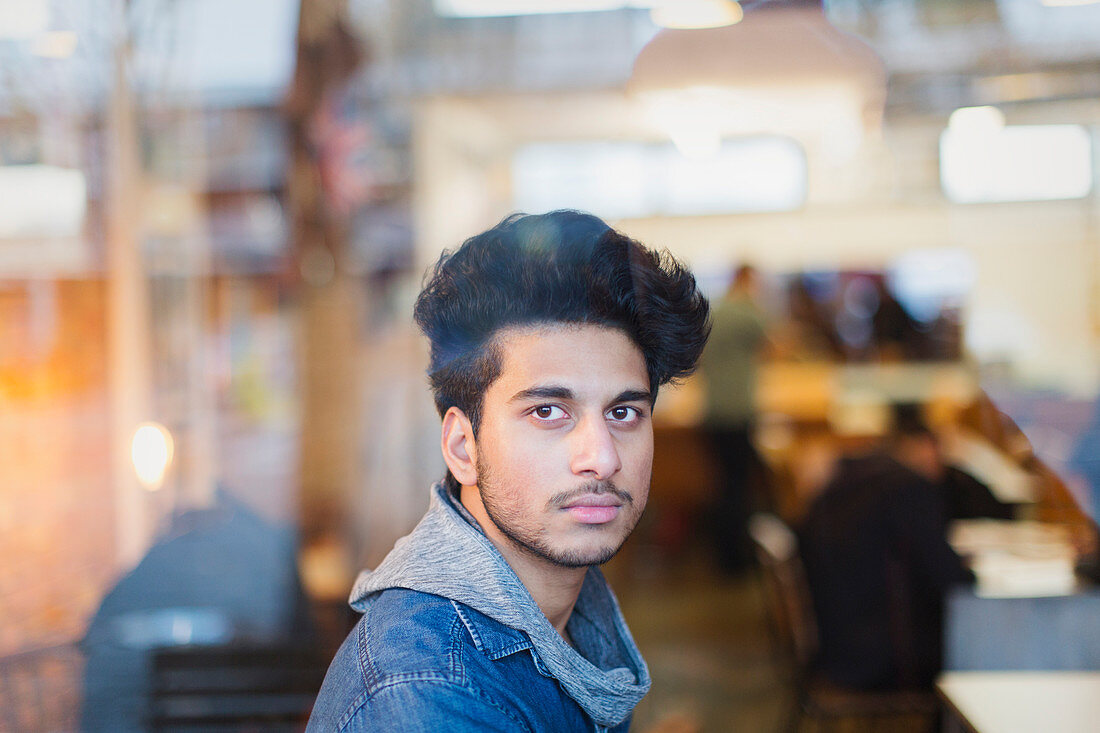 Portrait young man in cafe window