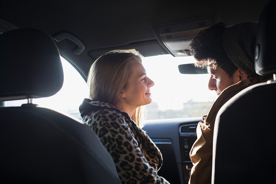 Young couple talking in car