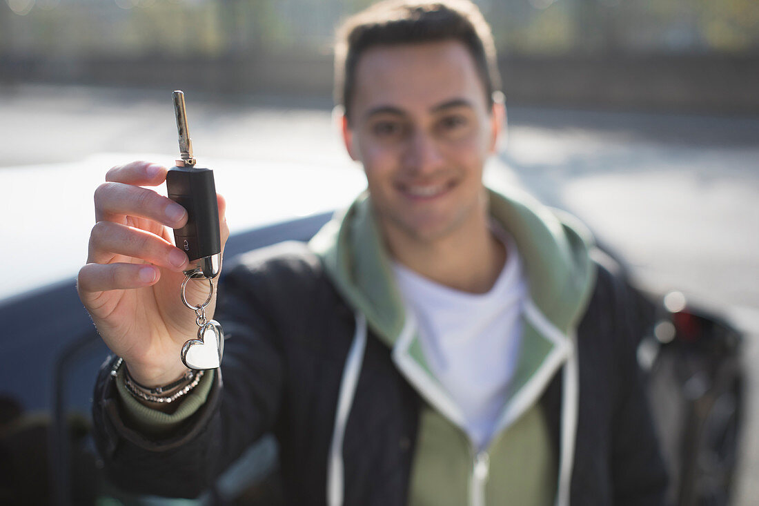 Portrait young man with new car key