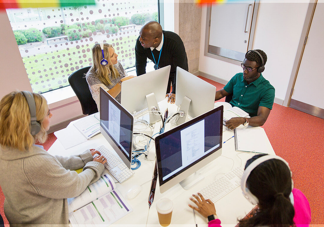 Instructor helping students using computers