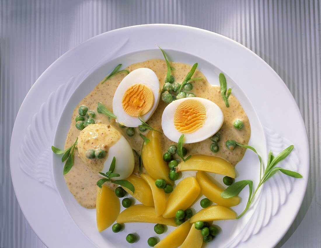 Boiled eggs with mustard & pepper sauce, peas & potatoes
