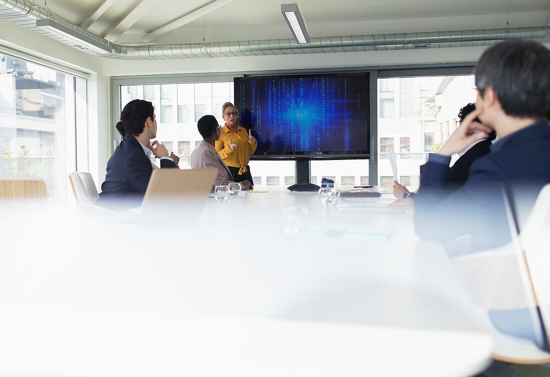 Businesswoman leading conference room meeting