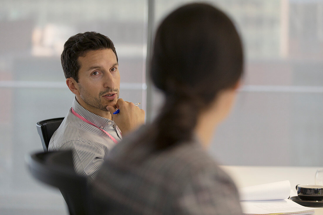 Attentive businessman listening to colleague in meeting