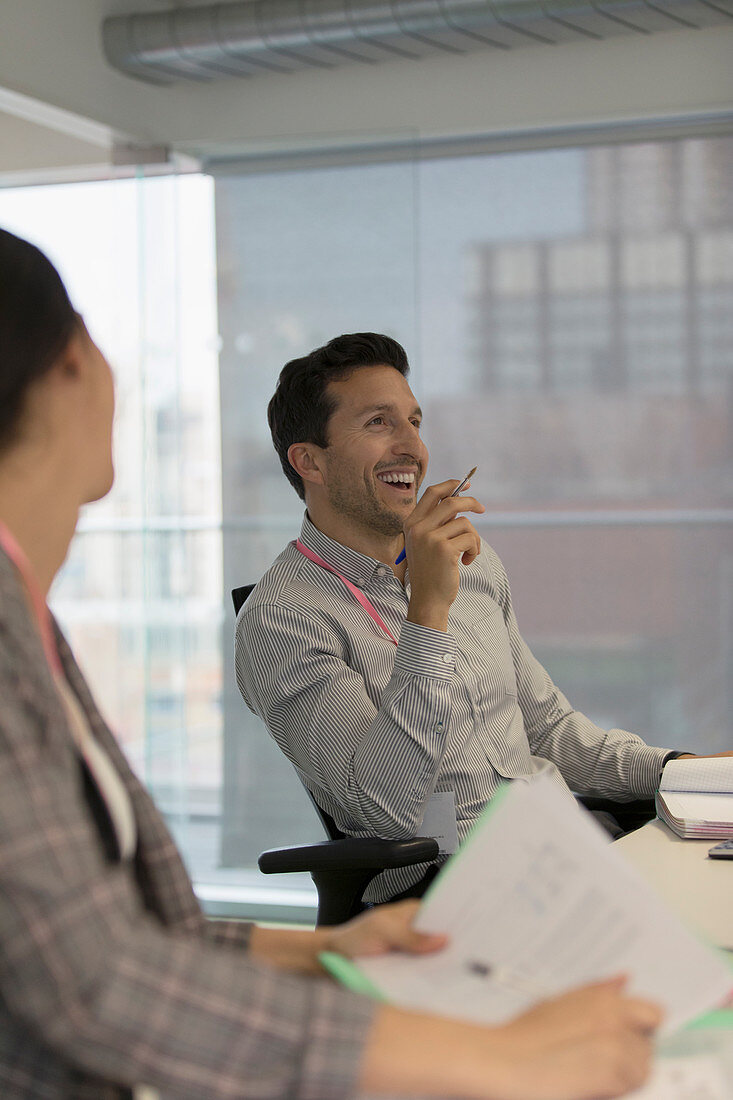 Laughing businessman in conference room meeting