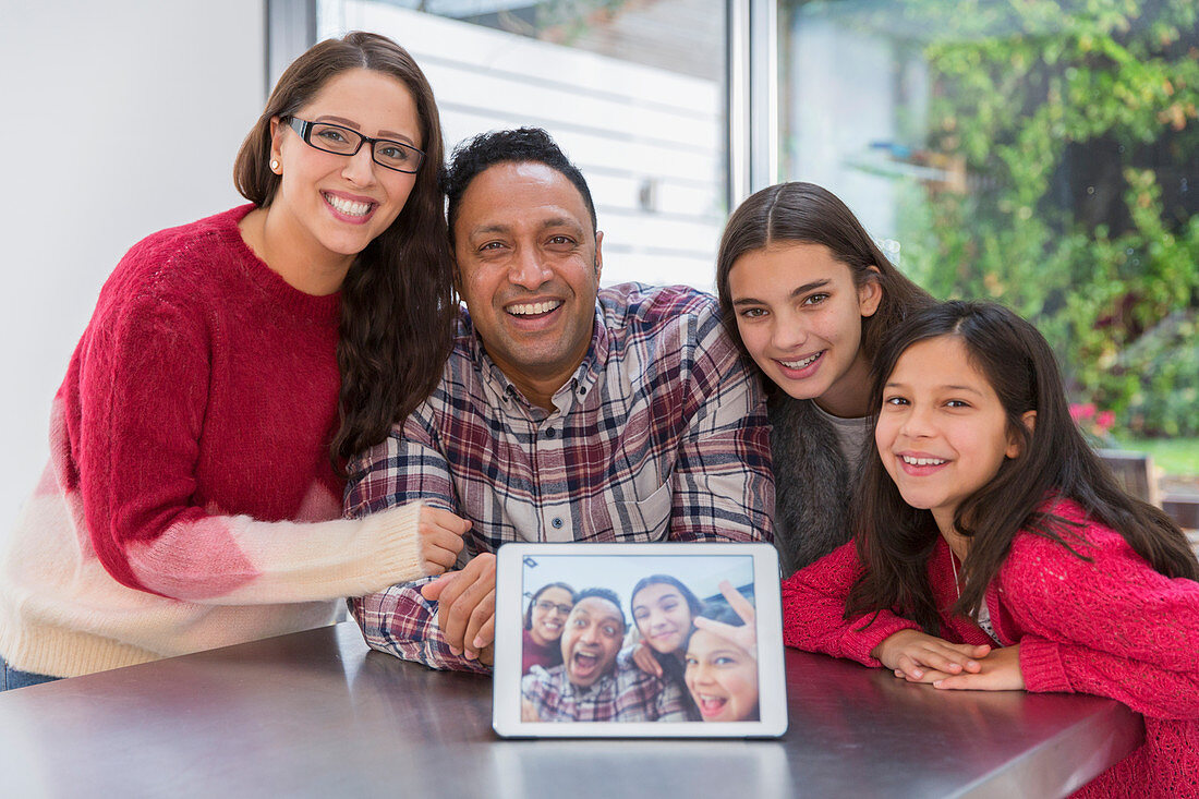 Portrait happy family with digital tablet selfie