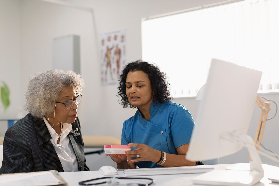 Doctor prescribing medication to senior patient