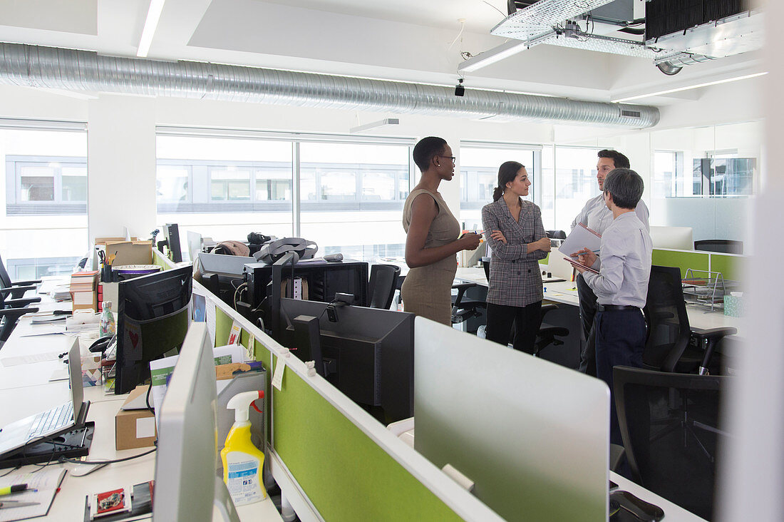 Business people talking, meeting in open plan office