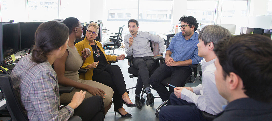 Business people talking, meeting in open plan office