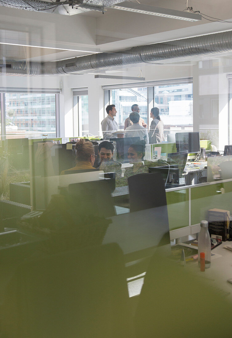 Business people working in open plan office