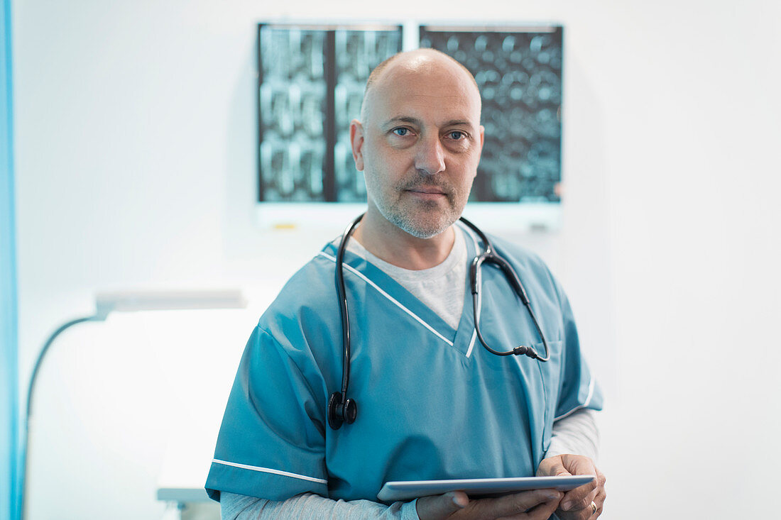 Portrait male doctor using digital tablet in hospital