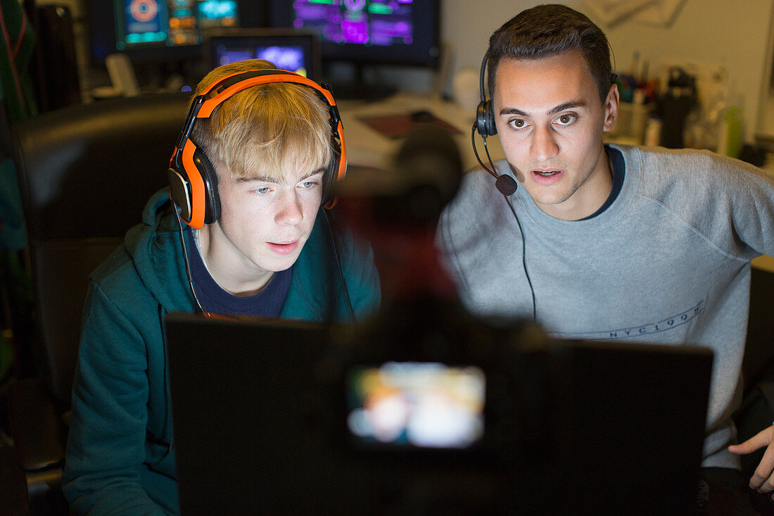 Boys with headphones playing video game