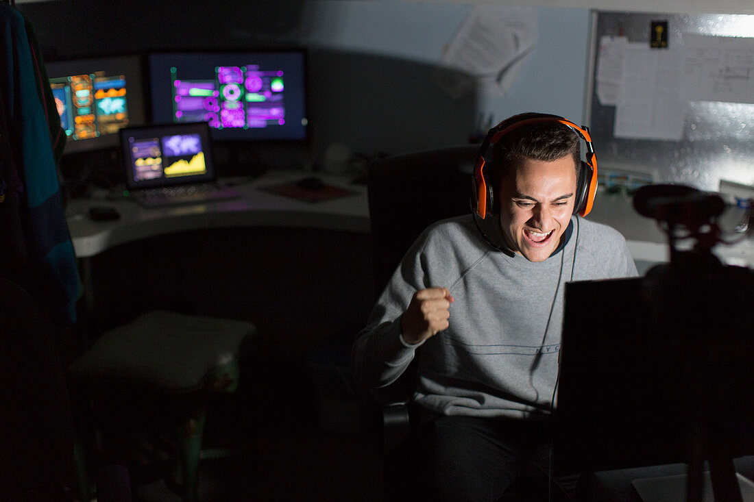 Excited teenage boy playing video game
