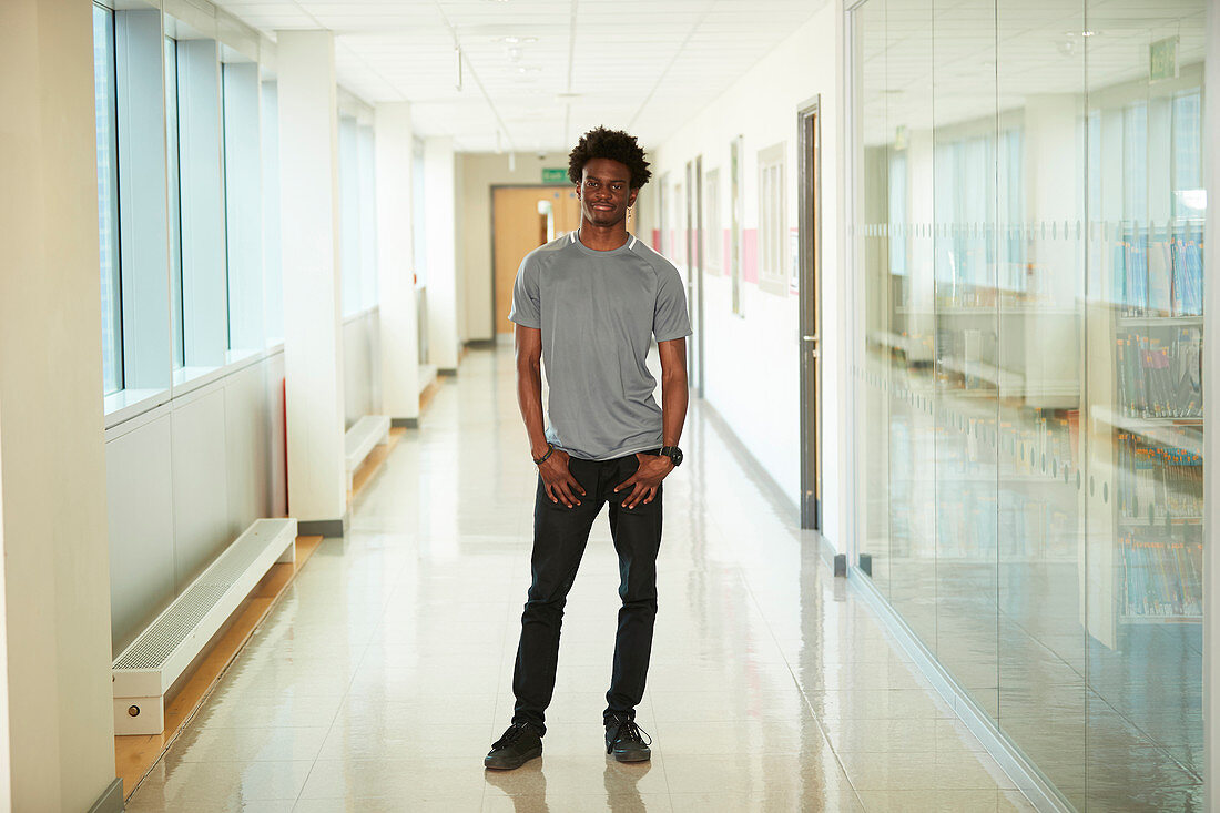 Portrait male college student in corridor