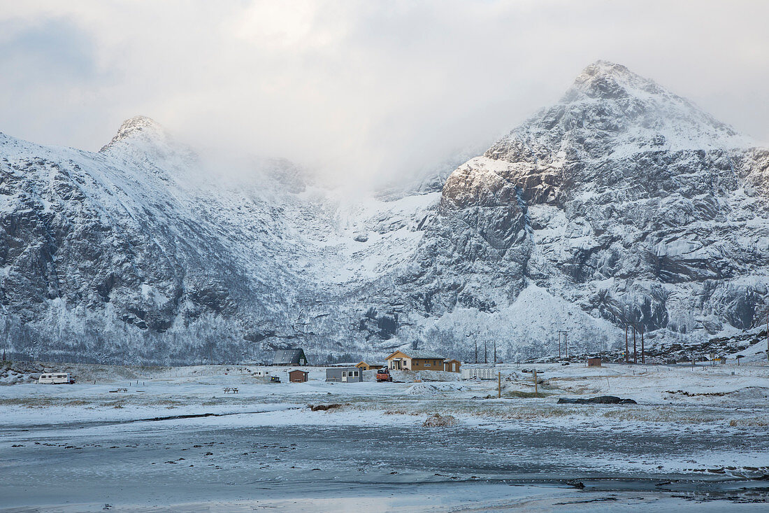Snow covered mountains and remote cabins
