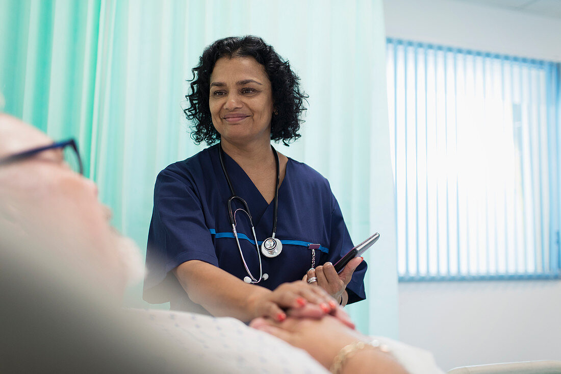 Smiling doctor with tablet making rounds