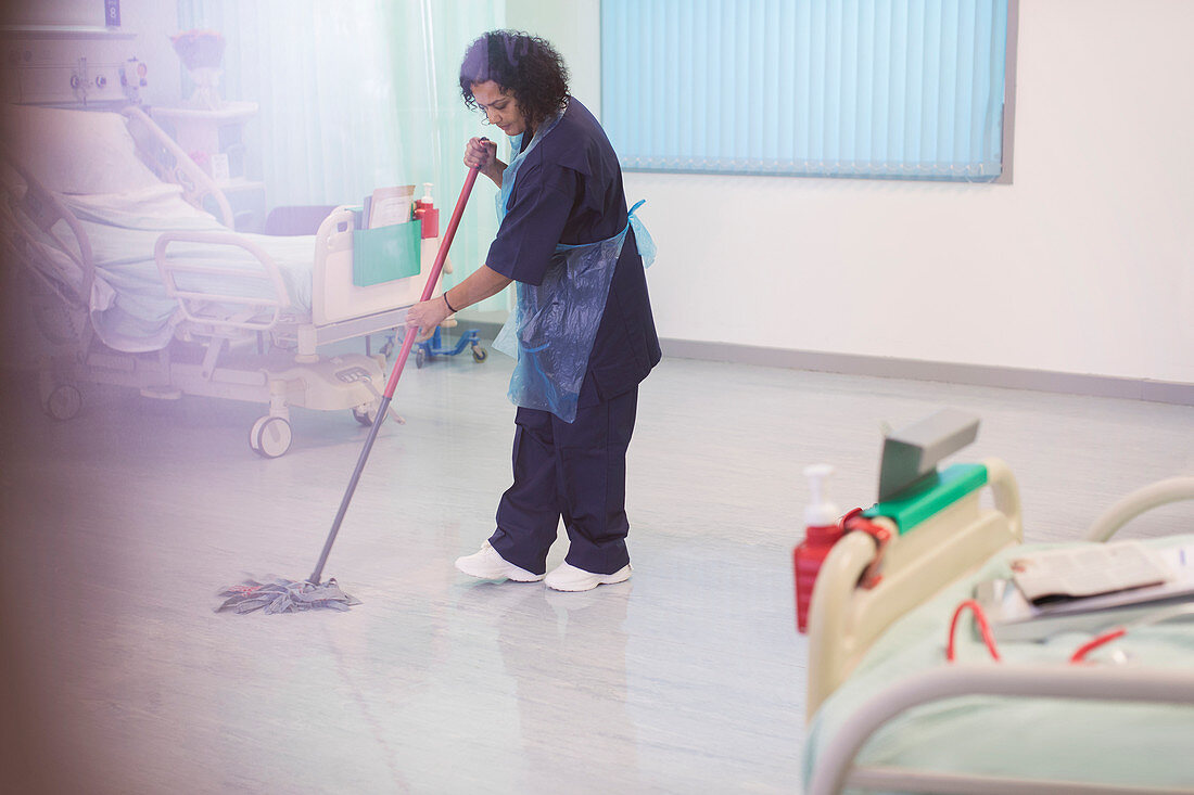 Female orderly mopping hospital ward floor